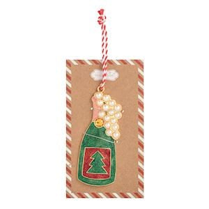 Green champagne bottle enamel ornament with Christmas tree design on kraft gift tag
