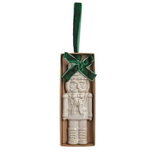 White ceramic nutcracker Christmas ornament with green velvet ribbon in kraft box