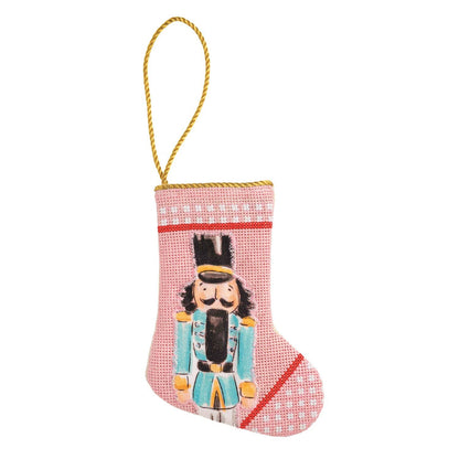 Pink mini needlepoint Christmas stocking ornament with nutcracker design and gold hanging loop