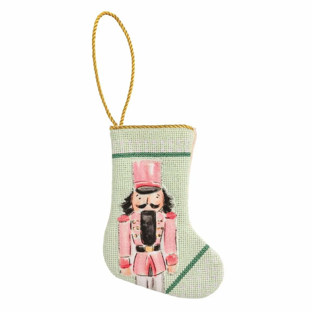 Mini needlepoint Christmas stocking ornament with pink nutcracker soldier on mint green background