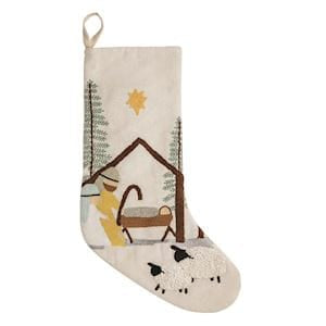 Cream Christmas stocking with embroidered nativity scene, manger, star, and sheep