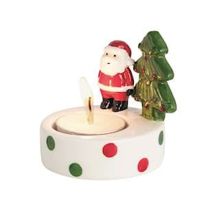 White ceramic Christmas tealight holder with Santa, tree figurines, and polka dots