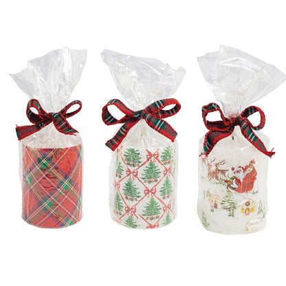 Three Christmas flameless pillar candles in plaid, tree, and Santa designs with tartan bows
