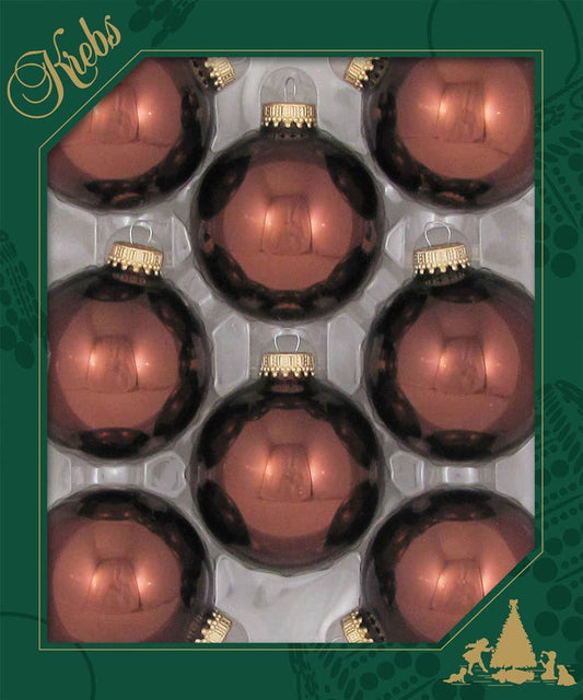 Eight shiny brown glass Christmas ball ornaments with gold caps in retail packaging, top view