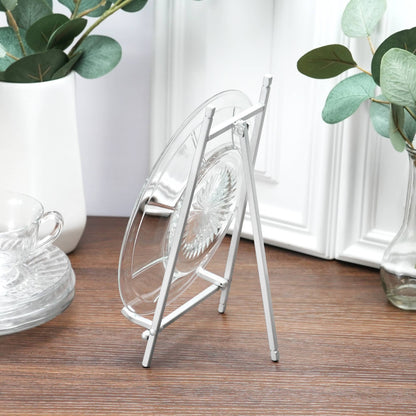 Satin silver metal plate easel displaying a clear glass plate on a wood surface