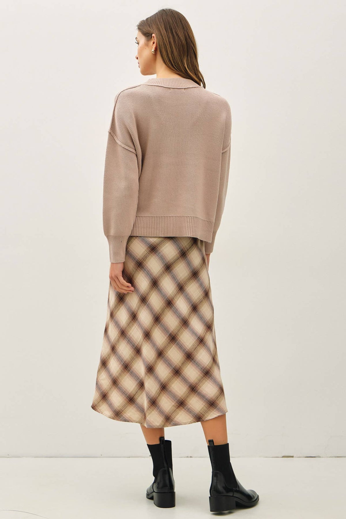 Relaxed taupe ribbed knit sweater with polo collar, worn with plaid midi skirt