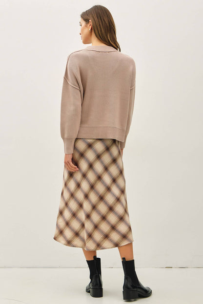 Relaxed taupe ribbed knit sweater with polo collar, worn with plaid midi skirt