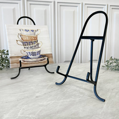 Black wrought iron display easel, 11 inches tall, shown with decorative tile on marble surface