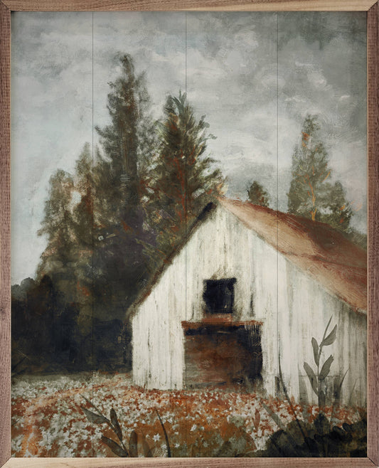Framed oil painting of a white barn surrounded by evergreen trees and wildflowers