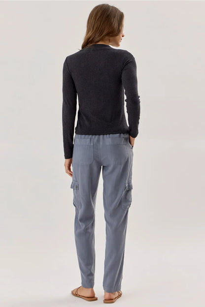 Charcoal gray long sleeve ribbed mockneck knit top, slim fit, worn with cargo pants