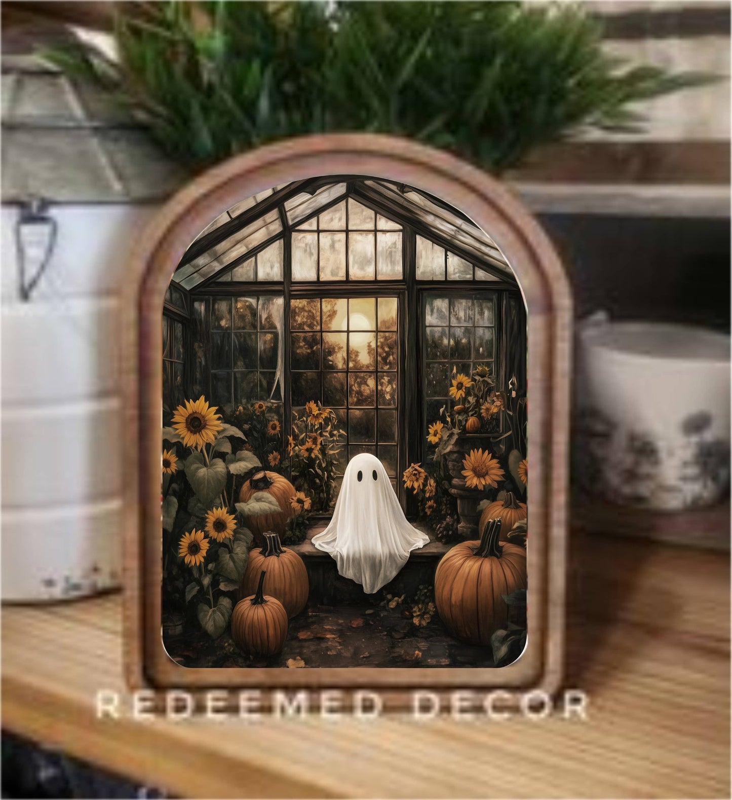 Arched wood-framed canvas art featuring ghost, pumpkins, sunflowers in dark greenhouse