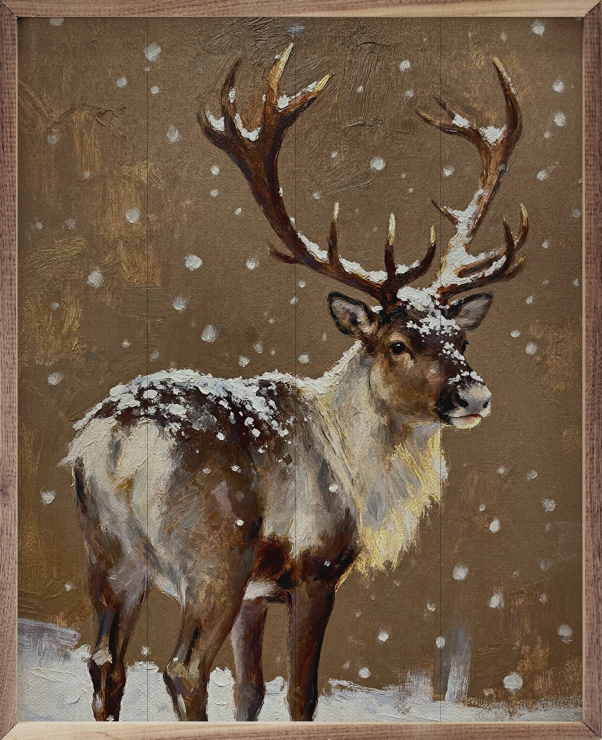 Framed oil painting of a reindeer with snow-dusted antlers standing in falling snow