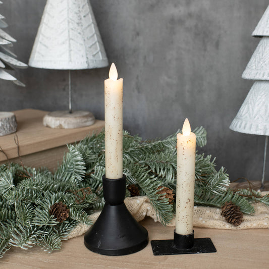 Set of 2 cream flameless taper candles in black iron holders with pine garland