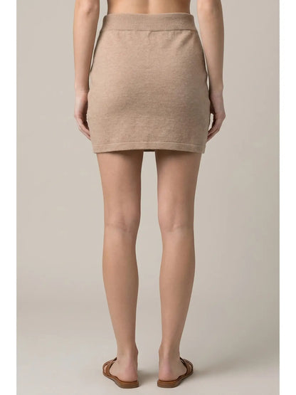 Doe and Rae beige knit mini skirt, back view, ribbed waistband, tan sandals