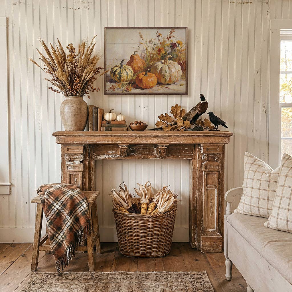 Framed autumn pumpkin painting displayed above rustic wood mantel with fall decor
