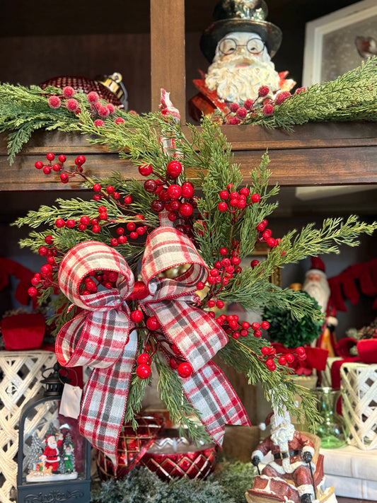 Green berry wreath with red holly berries and red plaid flannel bow