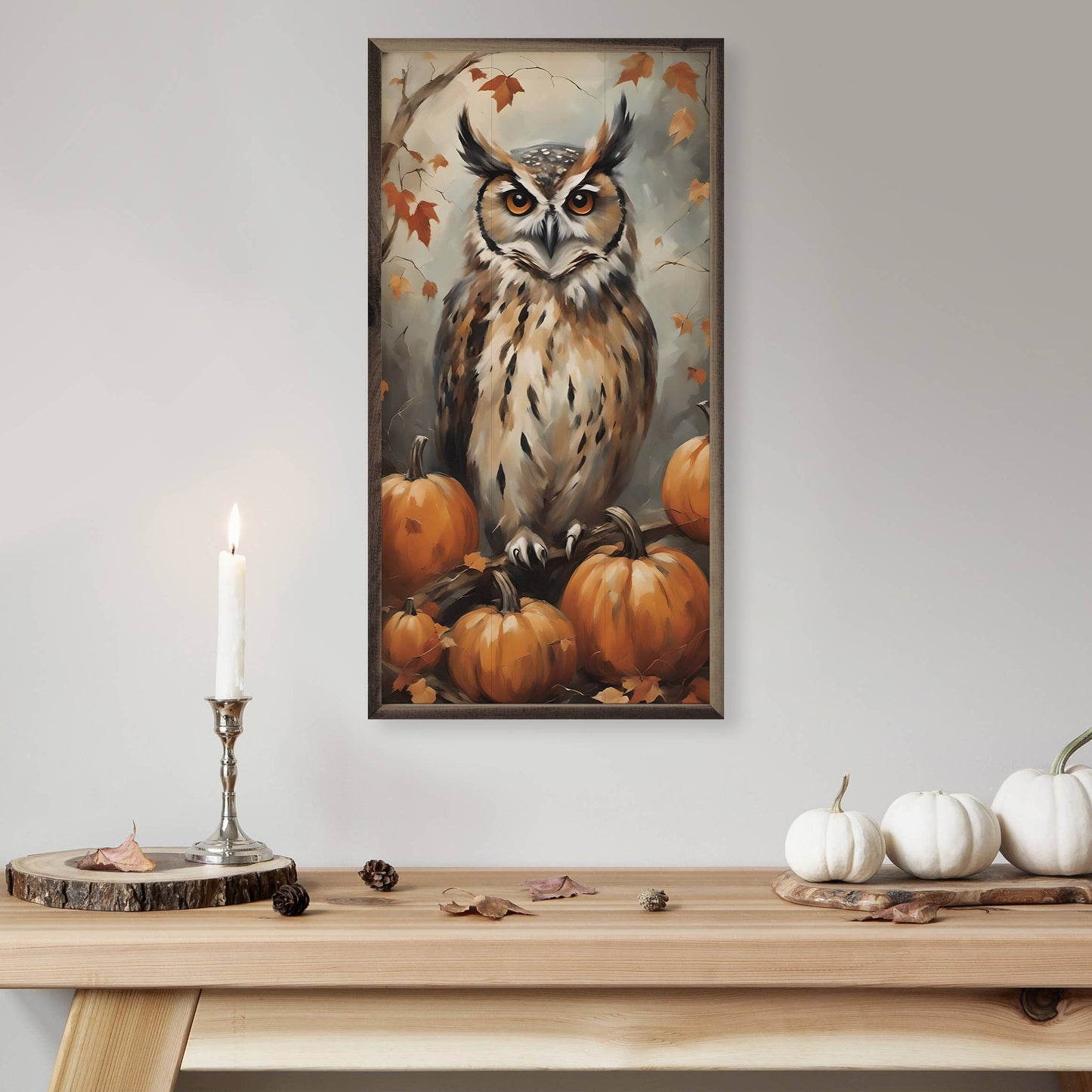 Framed autumn owl and pumpkins painting displayed above a wooden console table