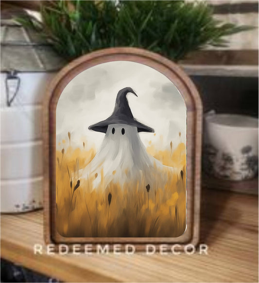 Framed canvas art of a ghost in witch hat standing in golden wheat field
