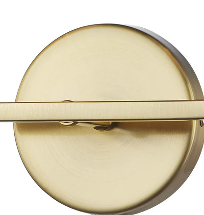 Brushed gold circular wall sconce backplate with horizontal brass arm detail