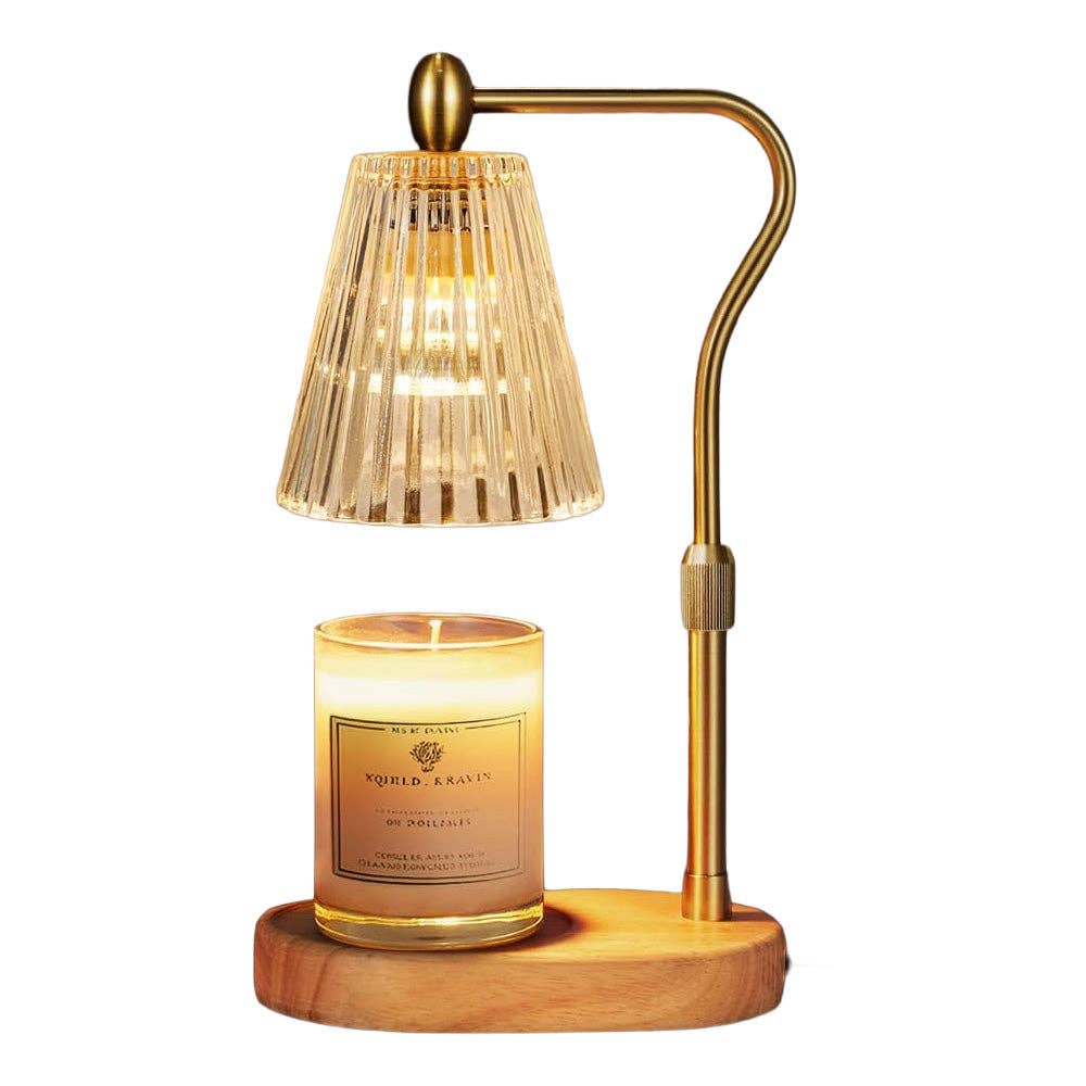 Gold candle warmer lamp with fluted amber glass shade over scented candle on wood base