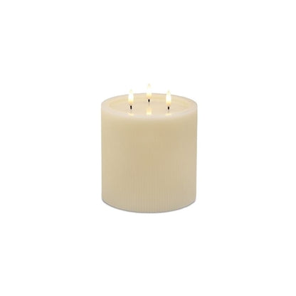 Large ivory ribbed pillar candle with three flickering LED flames, front view