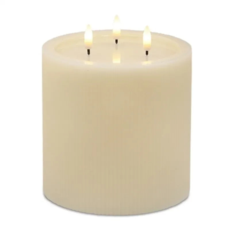 Large ivory pillar candle with three flickering wicks on top, ribbed texture sides