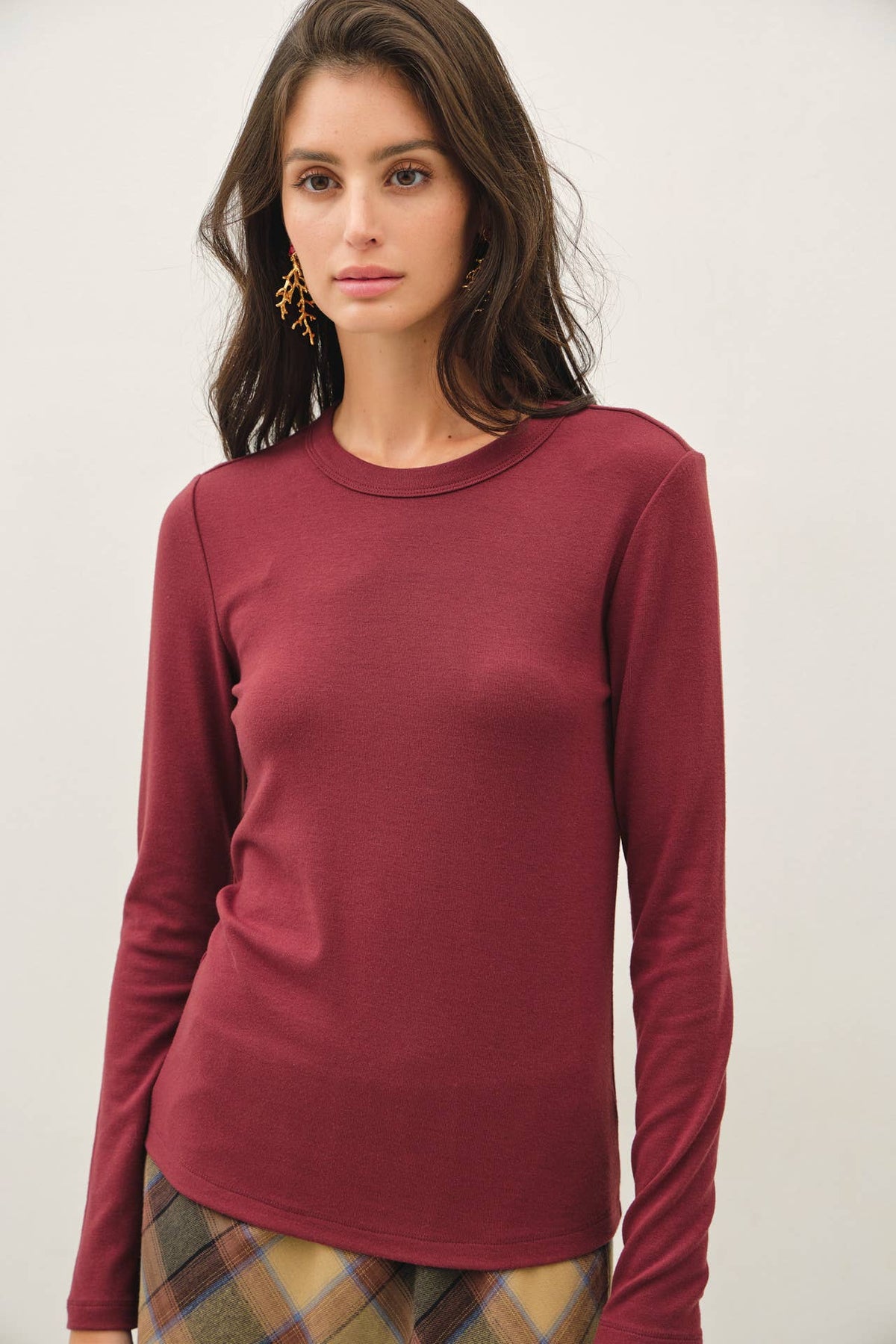 Be Cool burgundy round neck long sleeve fitted knit top on model