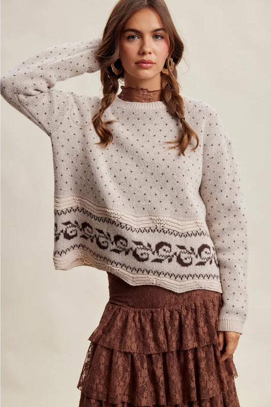 Cream knit sweater with Swiss dot pattern and dark floral border hem detail