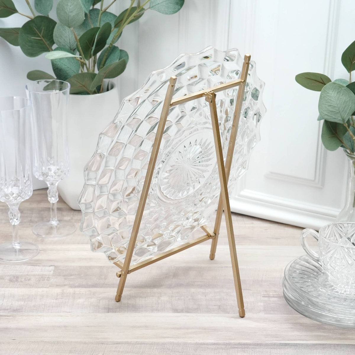 Gold satin metal easel stand displaying a clear cut crystal glass plate
