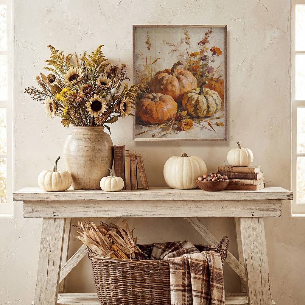 Framed painting of orange and green pumpkins with autumn wildflowers and grasses