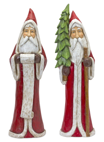 Two carved wooden Santa Claus figurines, one holding a scroll and one holding a Christmas tree and staff