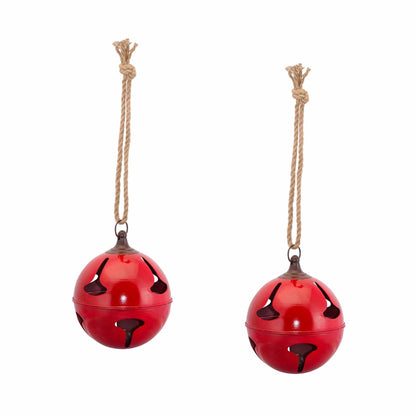 Two large red metal jingle bells with cutout star pattern, hanging from braided jute rope
