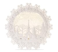 White laser-cut paper snow globe with church winter village scene and snowflake border