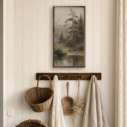 Framed pine forest oil painting print hung above rustic wood wall hook rack