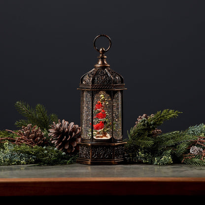 Antique bronze lantern-style snow globe with red cardinal birds on a Christmas tree inside
