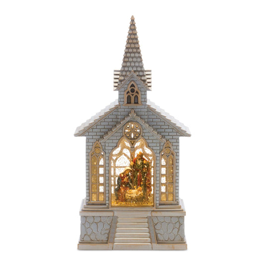 Illuminated church snow globe with Holy Family nativity scene inside, steeple top, front view