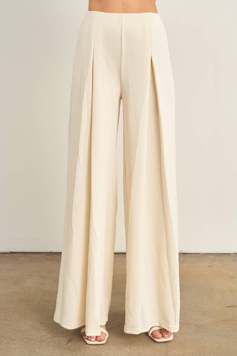 Cream wide-leg palazzo pants with pleated front detail and high waist
