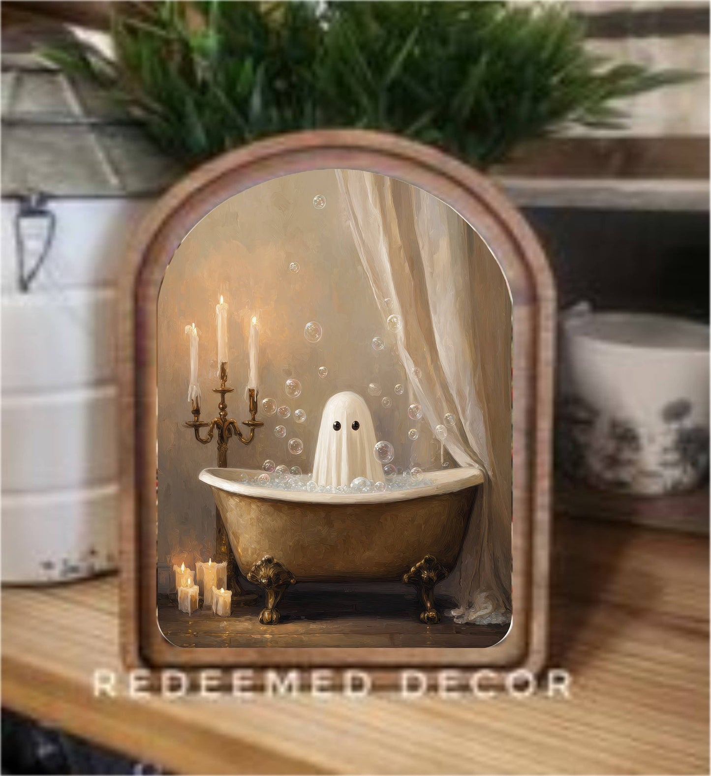 Arched wood-framed canvas art of a ghost in a gold clawfoot bathtub with candles