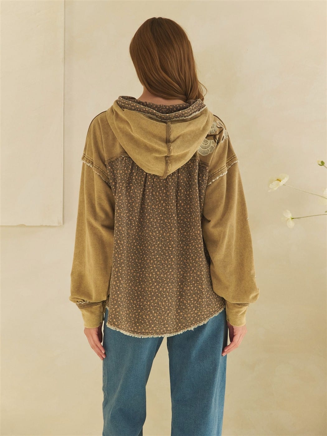 Olive washed hoodie with floral back panel, lace detail, and raw hem edges