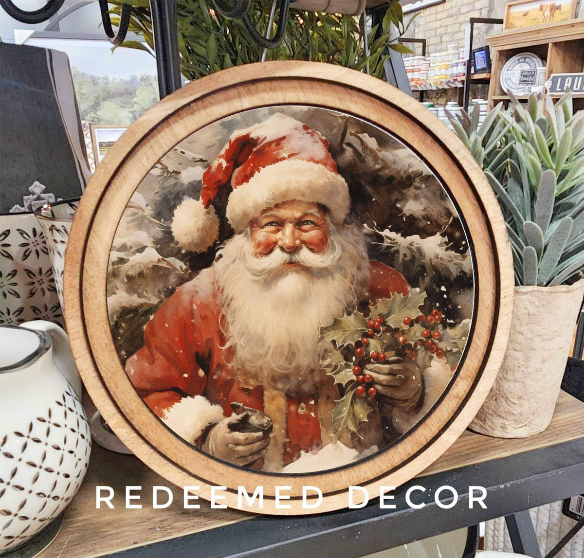 Round wooden framed Santa Claus canvas art holding holly berries, 8 inch