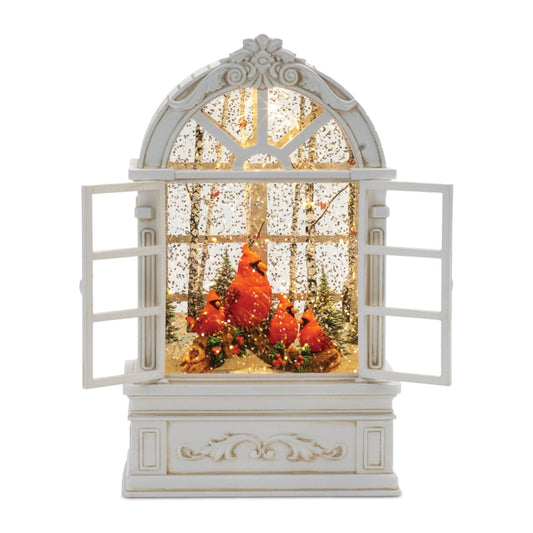 Illuminated snow globe shaped as an arched window with red cardinals in a winter forest scene