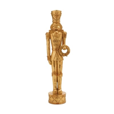 Gold nutcracker soldier statue holding a wreath, standing on a drum base