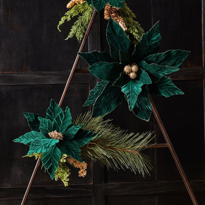Velvet poinsettia stems with gold berries and pine accents displayed on a decorative ladder