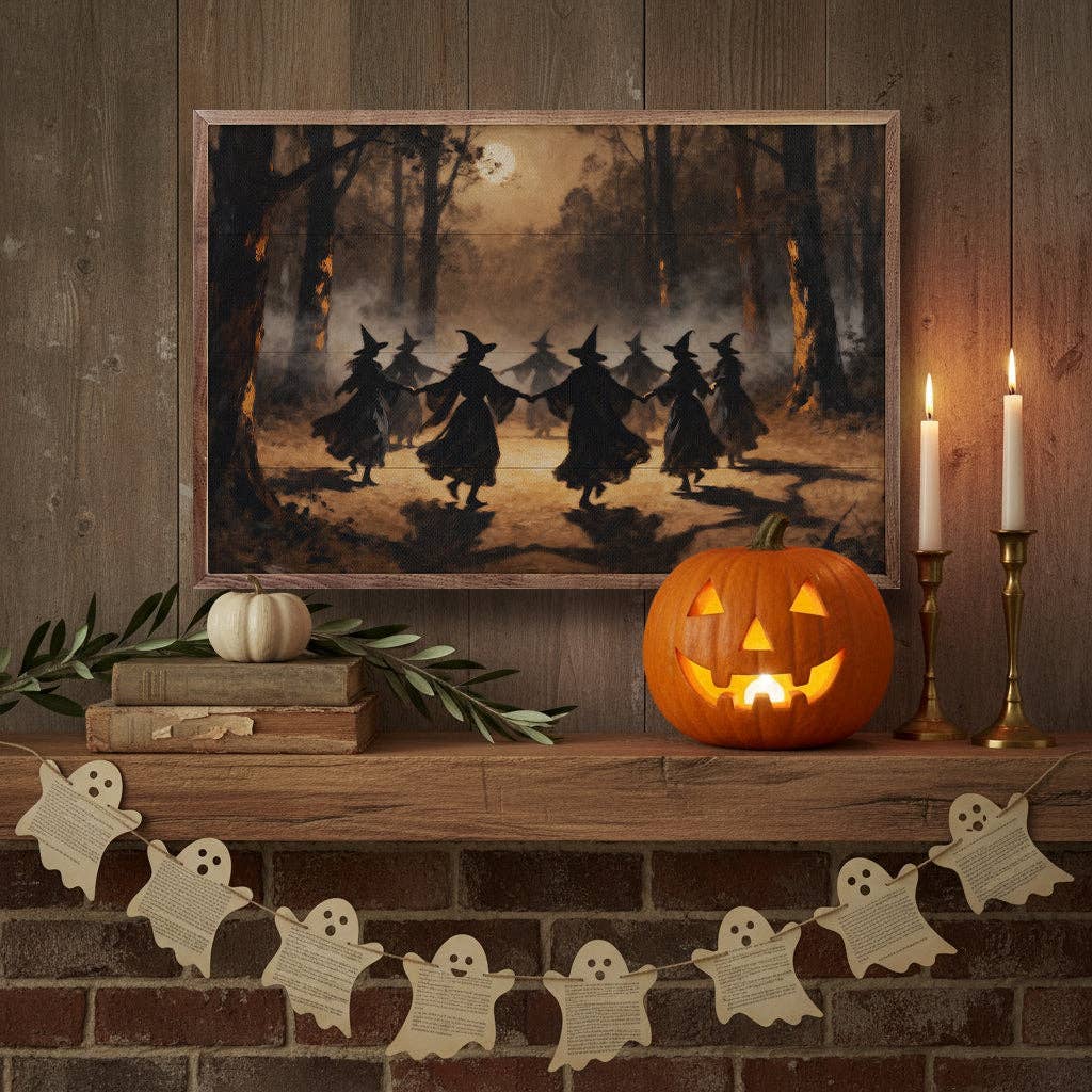 Framed witches dancing in moonlit woods print on Halloween mantel with jack-o-lantern and candles