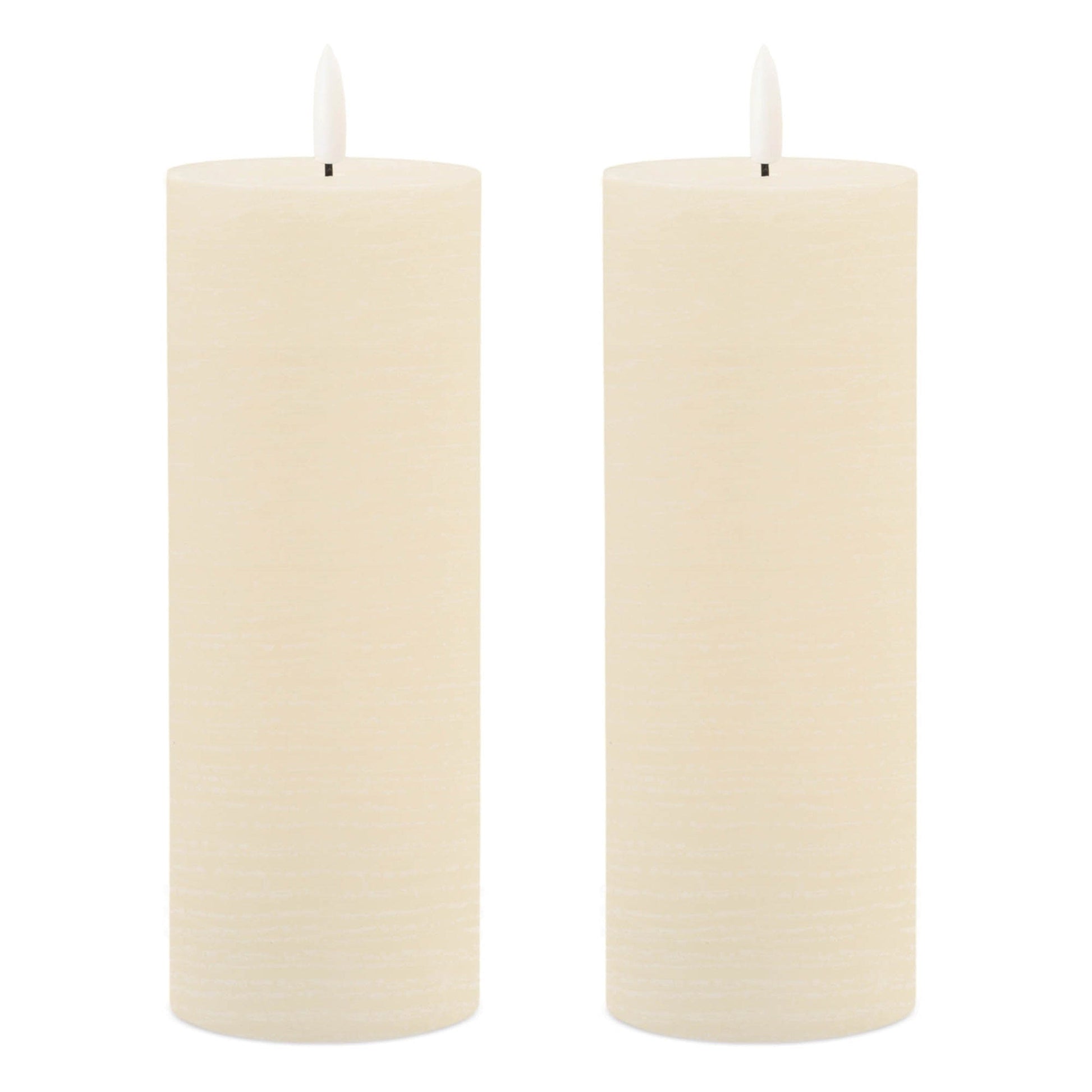 Set of two ivory pillar flameless candles with LED wicks on white background