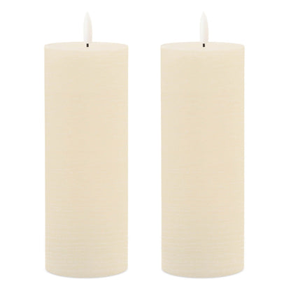Set of two ivory flameless pillar candles with LED wicks on white background
