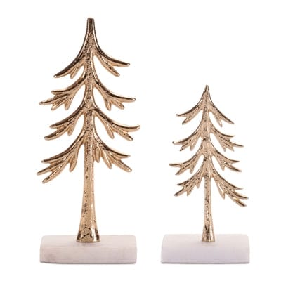 Two gold metal pine tree figurines on white marble bases, small and large