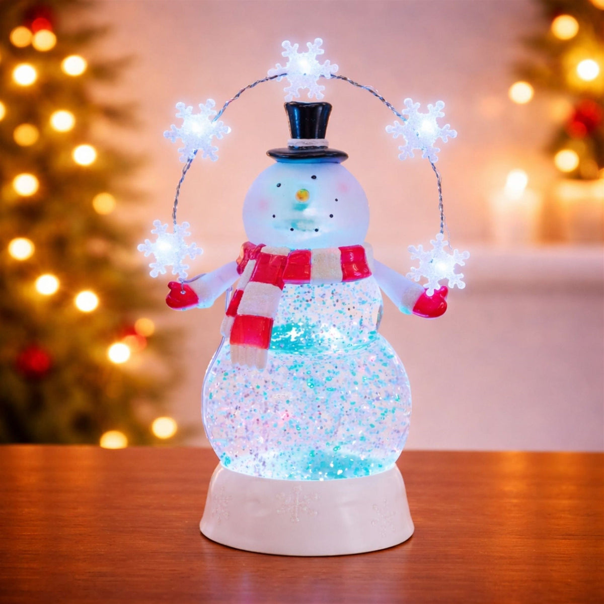 Illuminated snowman snow globe with red scarf, top hat, and lit snowflake arch, front view