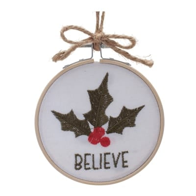 Round embroidery hoop ornament with holly leaves, red berries, and BELIEVE text