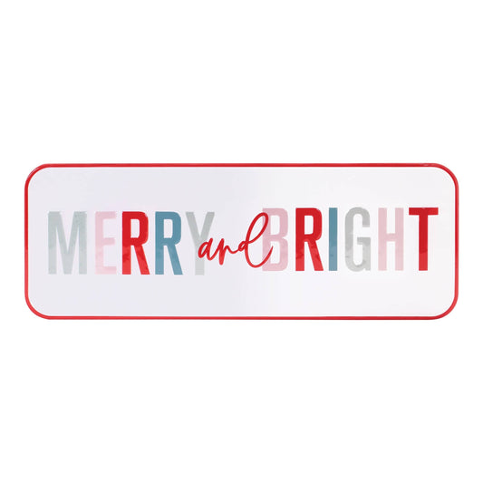 Rectangular white metal sign with red border reading 'Merry and Bright' in multicolor letters